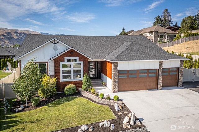 453 Spruce Ct NW, East Wenatchee, WA 98802 - view of front of home with a shingled roof, board and batten siding, and an attached garage