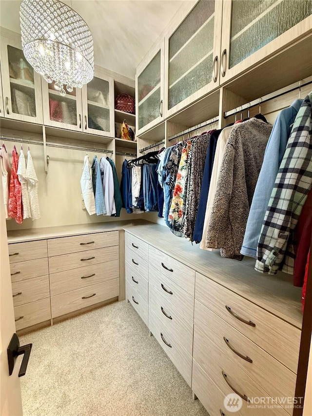 453 Spruce Ct NW, East Wenatchee, WA 98802 - walk in closet featuring light colored carpet and a chandelier