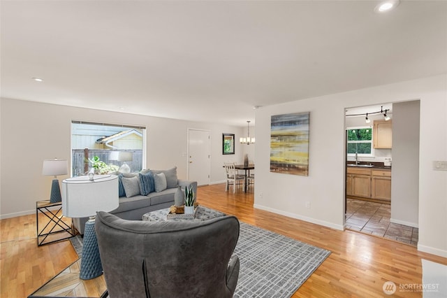 19508 23rd Ave NE, Shoreline, WA 98155 - living room with light wood finished floors and a chandelier