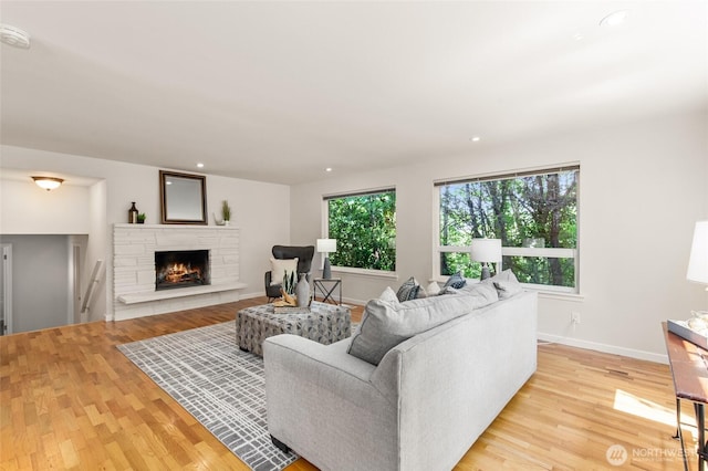 19508 23rd Ave NE, Shoreline, WA 98155 - living area featuring light wood finished floors, a fireplace, and recessed lighting