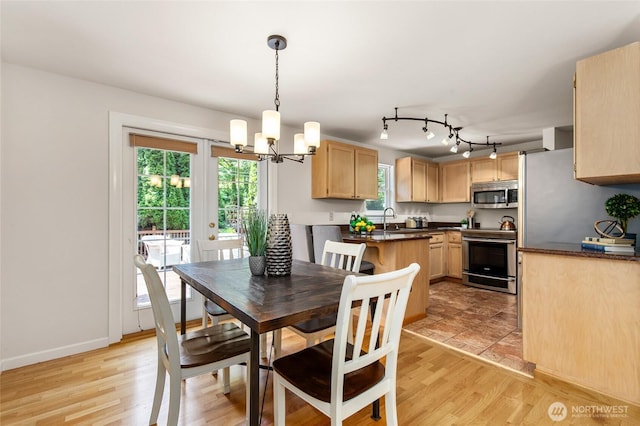 19508 23rd Ave NE, Shoreline, WA 98155 - dining room with a chandelier, light wood finished floors, and rail lighting