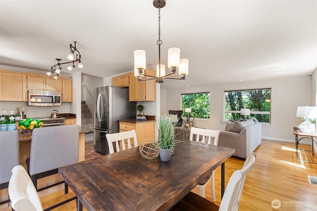 19508 23rd Ave NE, Shoreline, WA 98155 - dining area with stairs, a chandelier, and light wood-type flooring