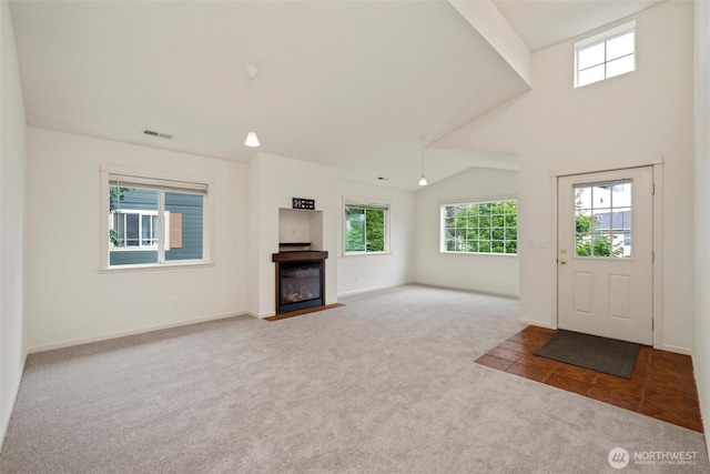 424 Wilson Ln, Sumas, WA 98295 - entryway with carpet floors, healthy amount of natural light, and a fireplace with flush hearth