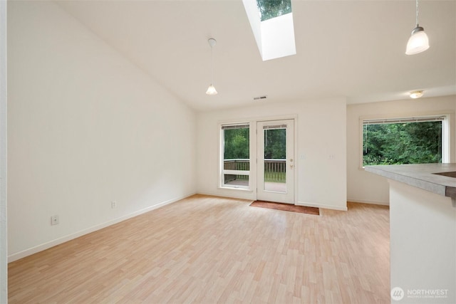 424 Wilson Ln, Sumas, WA 98295 - spare room with a skylight, lofted ceiling, and light wood-style floors
