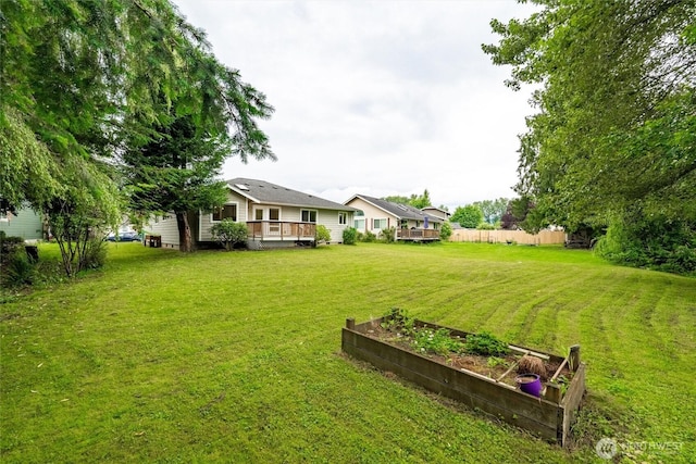 424 Wilson Ln, Sumas, WA 98295 - view of green lawn with a garden and a deck