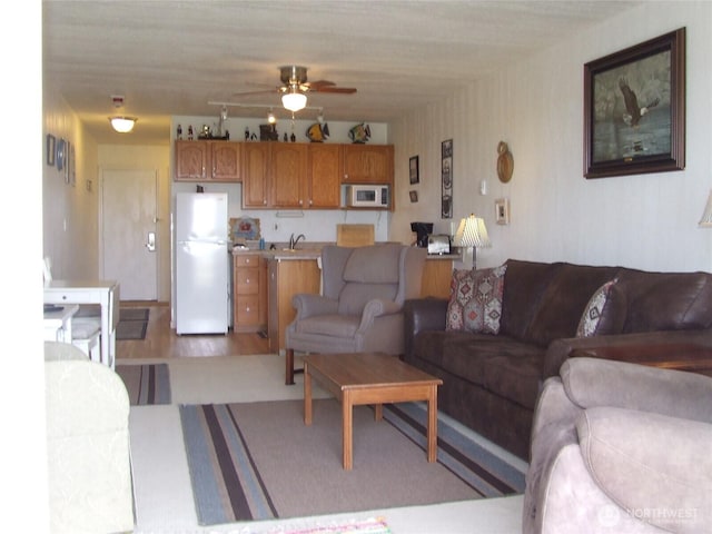 304 NW 14th St NW Unit 207, Long Beach, WA 98631 - living room with a ceiling fan and light wood-type flooring
