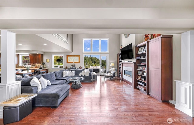 1301 Broad St, Bellingham, WA 98229 - living area with hardwood / wood-style flooring, a glass covered fireplace, recessed lighting, and a towering ceiling