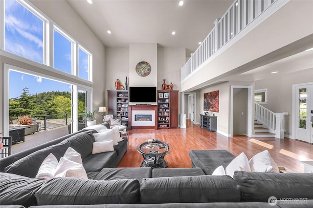 1301 Broad St, Bellingham, WA 98229 - living area featuring a high ceiling, stairway, recessed lighting, light wood-style flooring, and a glass covered fireplace
