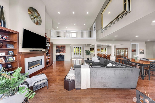1301 Broad St, Bellingham, WA 98229 - living area with a glass covered fireplace, wood finished floors, recessed lighting, and a towering ceiling