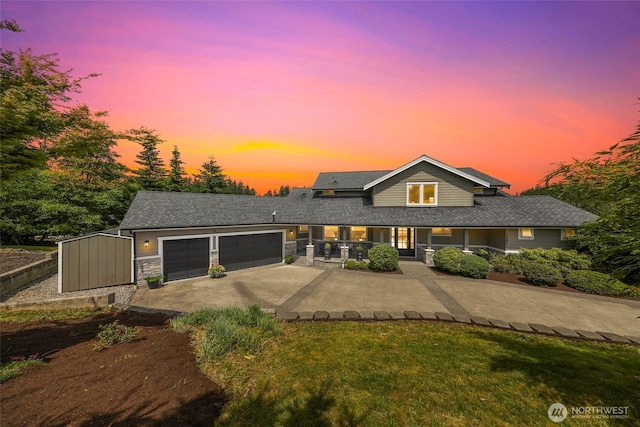 1301 Broad St, Bellingham, WA 98229 - view of front of property with concrete driveway, stone siding, and a garage