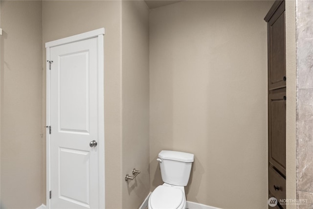 712 Syzygy Ct SE, Ocean Shores, WA 98569 - bathroom featuring baseboards and toilet