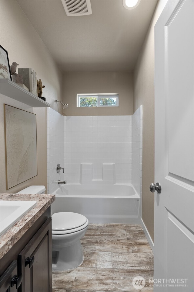 712 Syzygy Ct SE, Ocean Shores, WA 98569 - bathroom featuring wood finished floors, vanity, and bathtub / shower combination