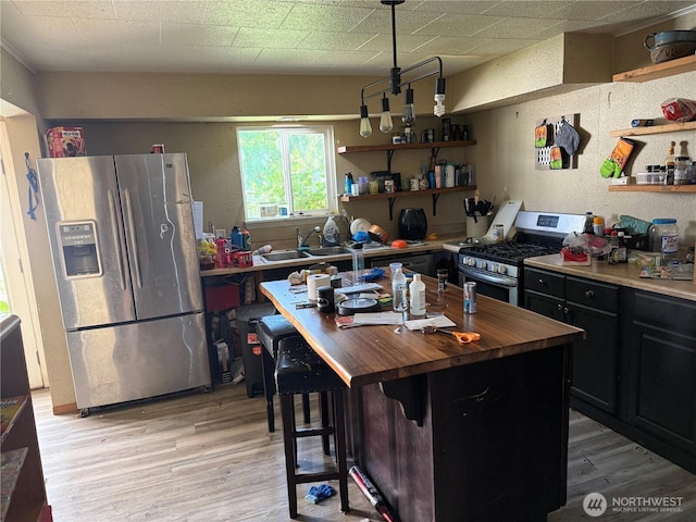 419 W Oak St, Mccleary, WA 98557 - kitchen with stainless steel appliances, butcher block counters, open shelves, and light wood finished floors