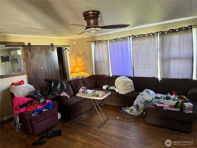 419 W Oak St, Mccleary, WA 98557 - living area featuring wood finished floors, a barn door, crown molding, ceiling fan, and a wall mounted AC