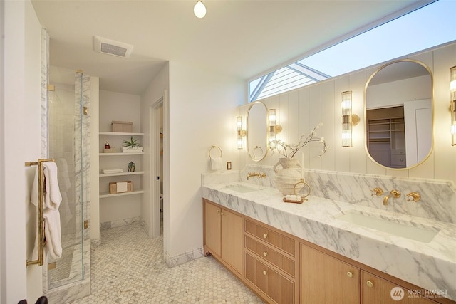 9208 11th Ave NW, Seattle, WA 98117 - bathroom featuring double vanity, a stall shower, a walk in closet, and tile patterned floors