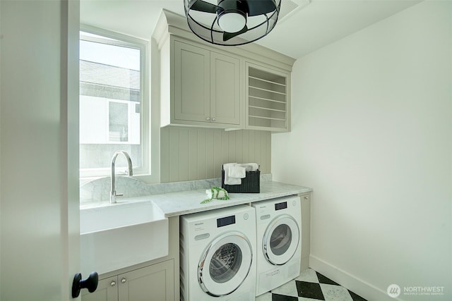9208 11th Ave NW, Seattle, WA 98117 - laundry room featuring washing machine and clothes dryer, tile patterned floors, and cabinet space