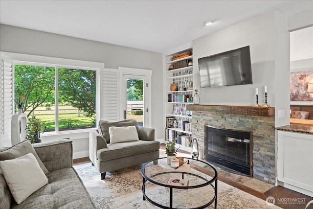 13228 202nd Ave SE, Issaquah, WA 98027 - living area with wood finished floors, a fireplace, and built in features