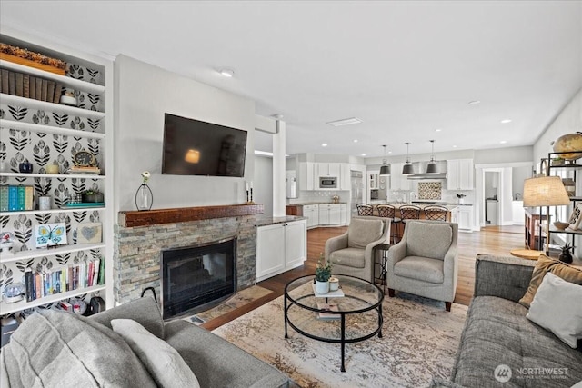 13228 202nd Ave SE, Issaquah, WA 98027 - living room with light wood-style flooring, a fireplace, and recessed lighting