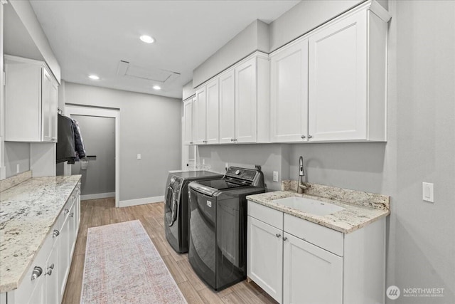 13228 202nd Ave SE, Issaquah, WA 98027 - laundry room with washing machine and clothes dryer, cabinet space, light wood-style flooring, recessed lighting, and attic access