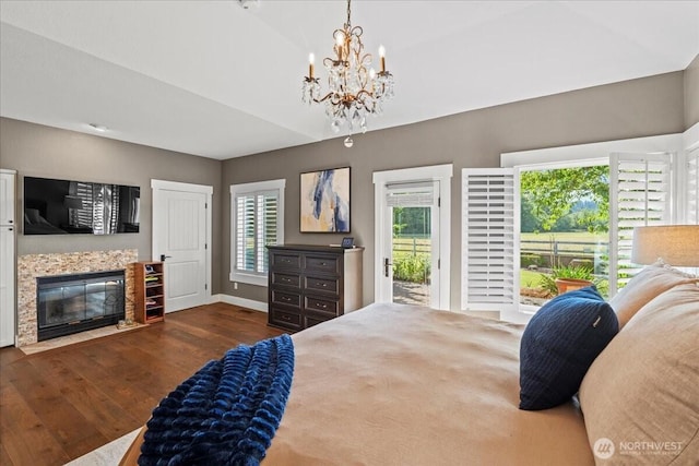 13228 202nd Ave SE, Issaquah, WA 98027 - bedroom with wood finished floors, access to outside, a chandelier, and a tiled fireplace