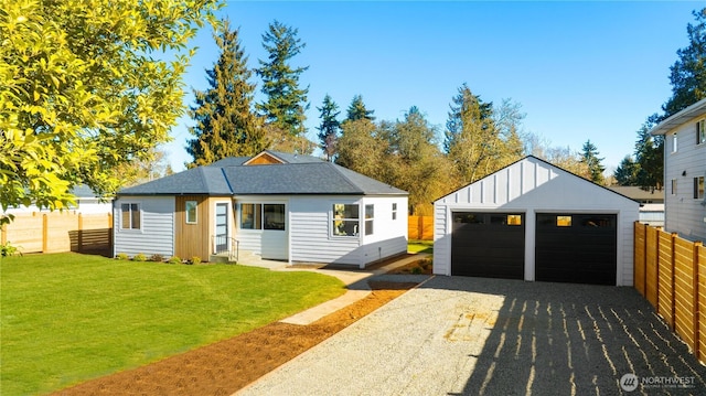 12852 Occidental Ave S, Seattle, WA 98168 - view of front of house featuring an outdoor structure, a detached garage, board and batten siding, and roof with shingles