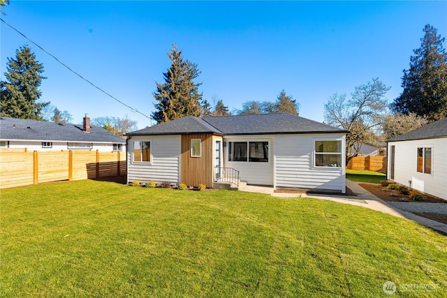 12852 Occidental Ave S, Seattle, WA 98168 - rear view of house featuring a fenced backyard and a shingled roof