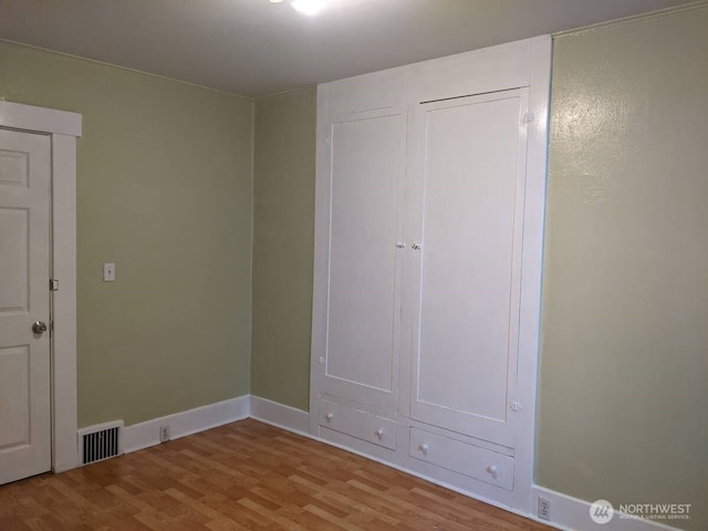 306 2nd St NE, Auburn, WA 98002 - unfurnished bedroom with wood finished floors and baseboards