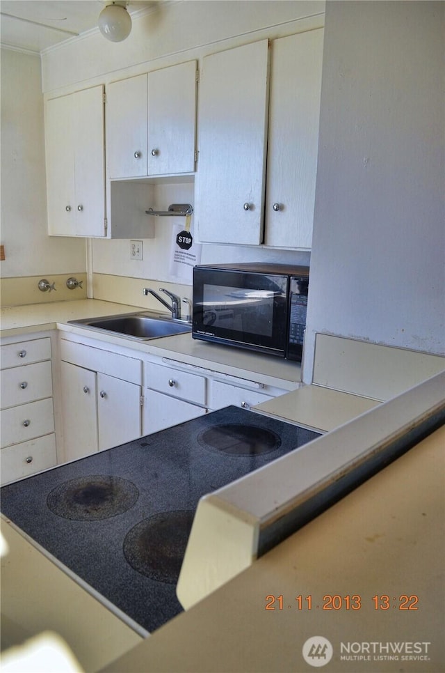 306 2nd St NE, Auburn, WA 98002 - kitchen featuring black microwave, white cabinets, and light countertops
