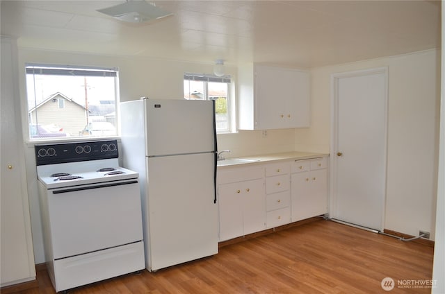306 2nd St NE, Auburn, WA 98002 - kitchen with white appliances, white cabinetry, healthy amount of natural light, and light wood finished floors