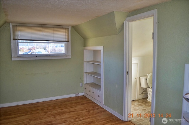 306 2nd St NE, Auburn, WA 98002 - bonus room with wood finished floors, a textured ceiling, and vaulted ceiling