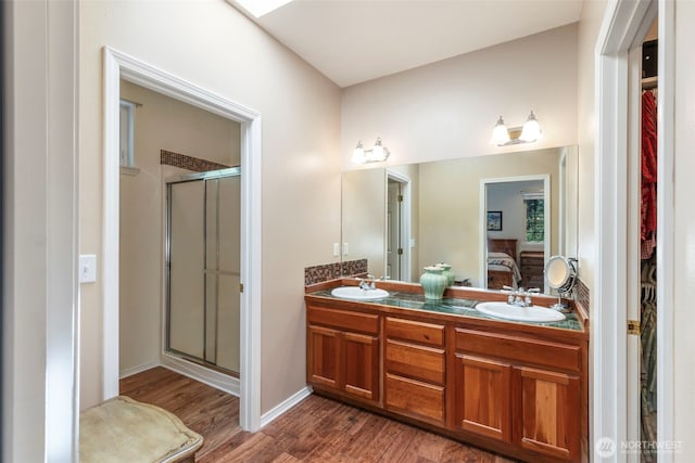 4766 Mason St, Port Townsend, WA 98368 - full bath with a walk in closet, wood finished floors, connected bathroom, double vanity, and a shower stall