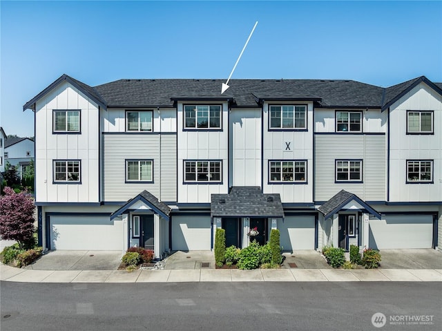 1621 Seattle Hill Rd Unit X2, Bothell, WA 98012 - view of property with an attached garage, board and batten siding, driveway, and roof with shingles