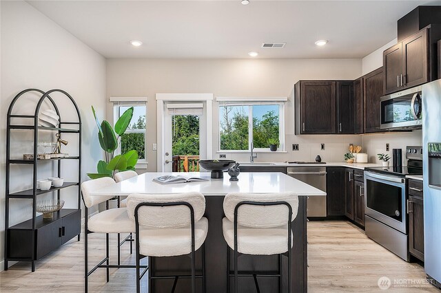 1621 Seattle Hill Rd Unit X2, Bothell, WA 98012 - kitchen featuring appliances with stainless steel finishes, a kitchen breakfast bar, a center island, light countertops, and recessed lighting