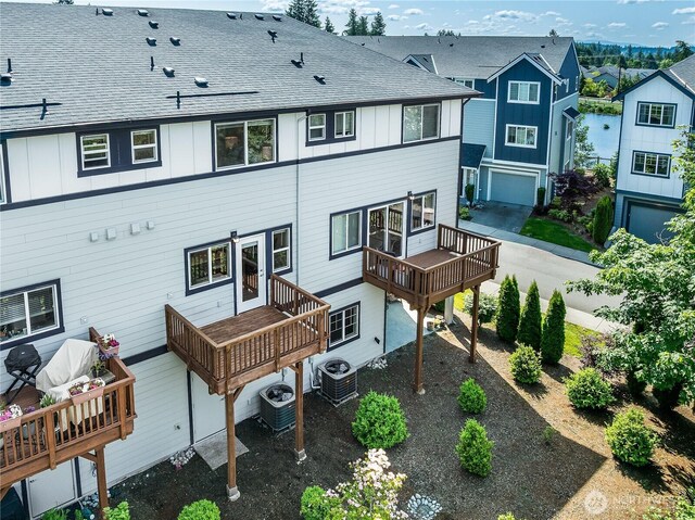 1621 Seattle Hill Rd Unit X2, Bothell, WA 98012 - back of property with board and batten siding, a wooden deck, an outdoor living space, and a shingled roof