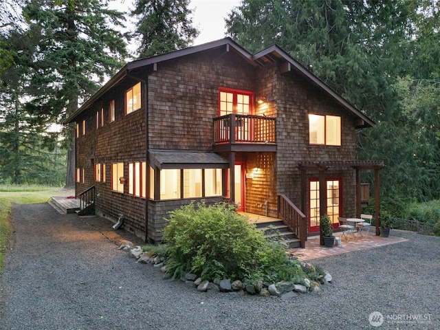14855 Phelps Rd NE, Bainbridge Island, WA 98110 - view of front of home featuring french doors, a balcony, a patio, and a pergola