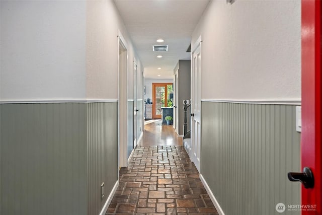 14855 Phelps Rd NE, Bainbridge Island, WA 98110 - hallway featuring wainscoting and brick floors