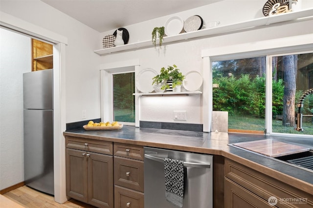 14855 Phelps Rd NE, Bainbridge Island, WA 98110 - kitchen featuring appliances with stainless steel finishes, open shelves, and light wood-style flooring