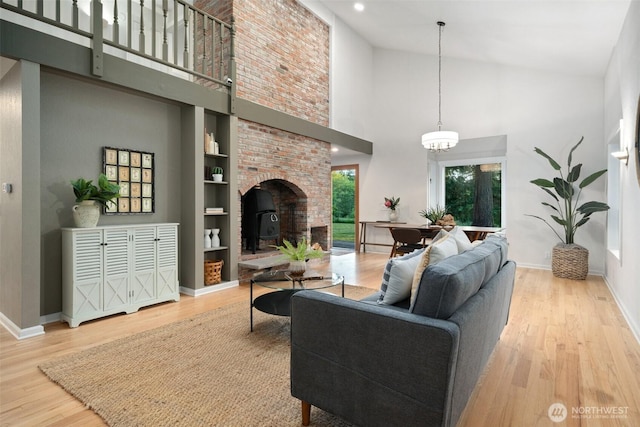 14855 Phelps Rd NE, Bainbridge Island, WA 98110 - living area with high vaulted ceiling, wood finished floors, a chandelier, built in features, and recessed lighting