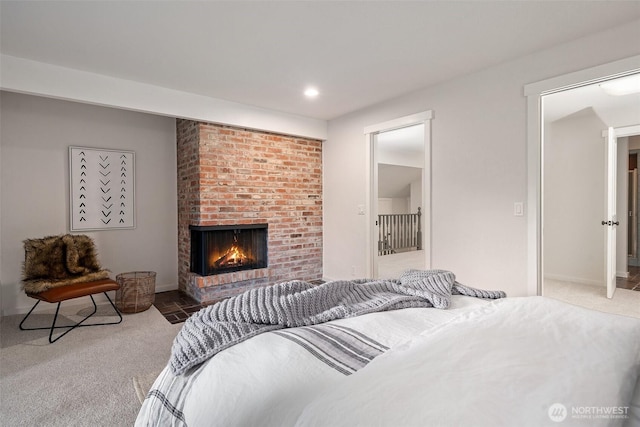 14855 Phelps Rd NE, Bainbridge Island, WA 98110 - bedroom with carpet floors, a brick fireplace, and recessed lighting