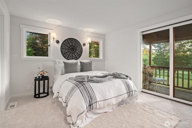 14855 Phelps Rd NE, Bainbridge Island, WA 98110 - bedroom featuring access to exterior, carpet flooring, and multiple windows