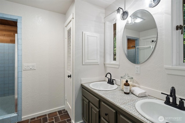 14855 Phelps Rd NE, Bainbridge Island, WA 98110 - full bathroom with double vanity, brick patterned floors, tiled shower, and a closet