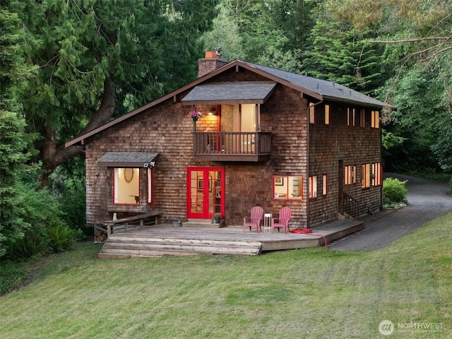 14855 Phelps Rd NE, Bainbridge Island, WA 98110 - view of front of home featuring a balcony, a chimney, a front lawn, french doors, and a wooden deck