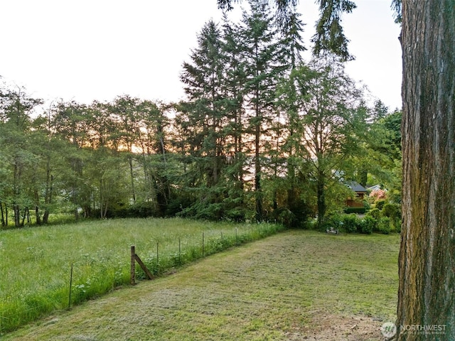 14855 Phelps Rd NE, Bainbridge Island, WA 98110 - view of green lawn featuring a wooded view