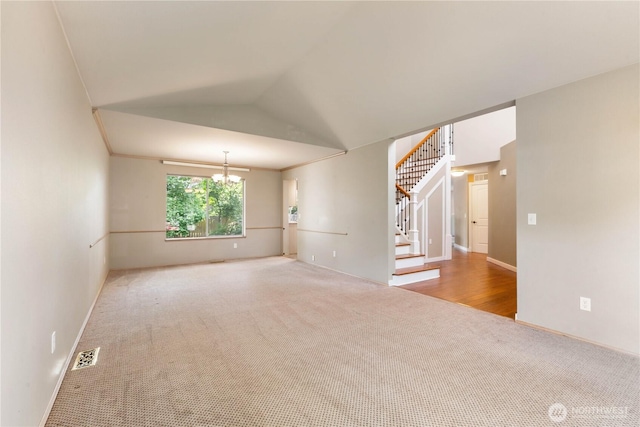 3035 Carbon Ridge St, Enumclaw, WA 98022 - empty room with carpet floors, stairs, a chandelier, and vaulted ceiling