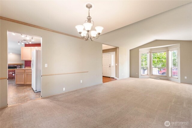 3035 Carbon Ridge St, Enumclaw, WA 98022 - empty room with light carpet, a chandelier, lofted ceiling, and ornamental molding