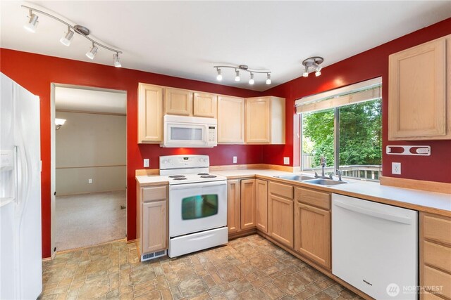 3035 Carbon Ridge St, Enumclaw, WA 98022 - kitchen featuring white appliances, light brown cabinetry, light countertops, stone finish flooring, and rail lighting