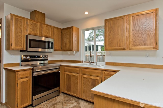 408 Cross Creek Ct, South Prairie, WA 98385 - kitchen featuring stainless steel appliances, light countertops, recessed lighting, and brown cabinets
