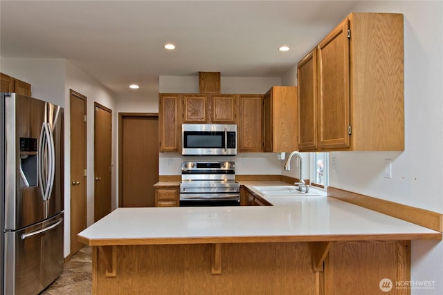 408 Cross Creek Ct, South Prairie, WA 98385 - kitchen featuring appliances with stainless steel finishes, light countertops, a peninsula, recessed lighting, and brown cabinets
