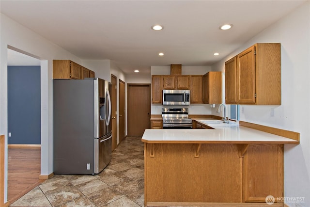 408 Cross Creek Ct, South Prairie, WA 98385 - kitchen with stainless steel appliances, a peninsula, recessed lighting, light countertops, and brown cabinets