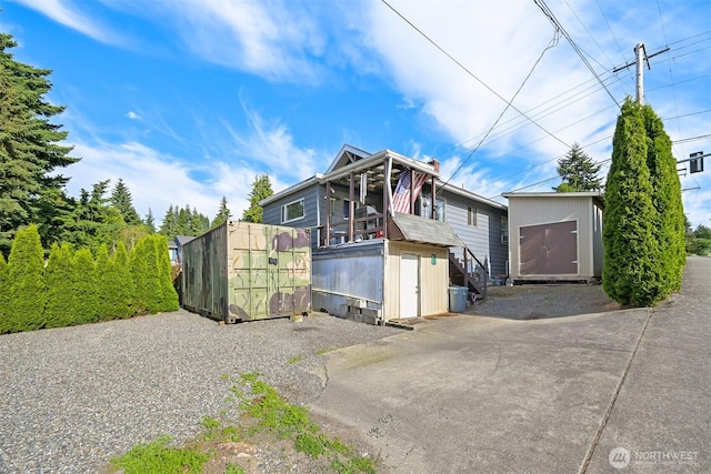 1501 Lakeway Dr, Bellingham, WA 98225 - view of front of property with a storage unit and a patio